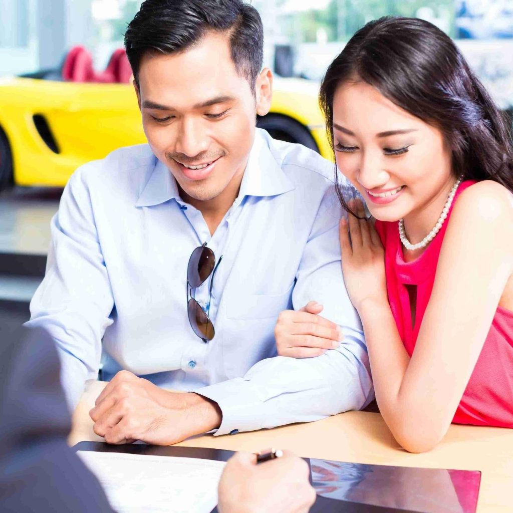 Couple signing finance documents
