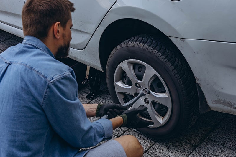 Technician repairing a car tire